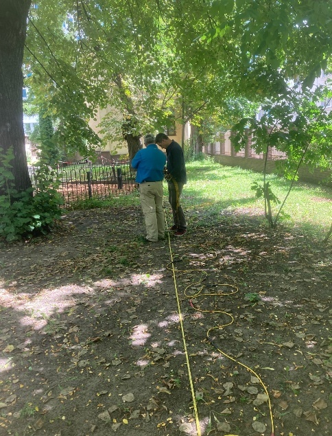 Researchers collecting electrical resistivity tomography data on the grounds of the Bersohn and Bauman Children’s Hospital.