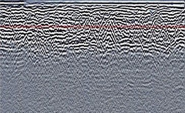 Corresponding ground-penetrating radar cross-section near the Livas Cemetery memorial showing several hyperbolic reflections at about 1 meter depth.