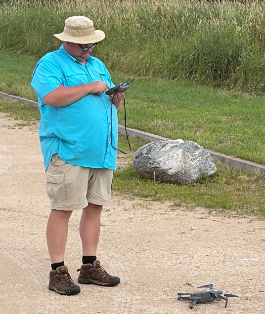 Martin Goettl preparing a drone for flight at the Jungfernhof Concentration Camp site.